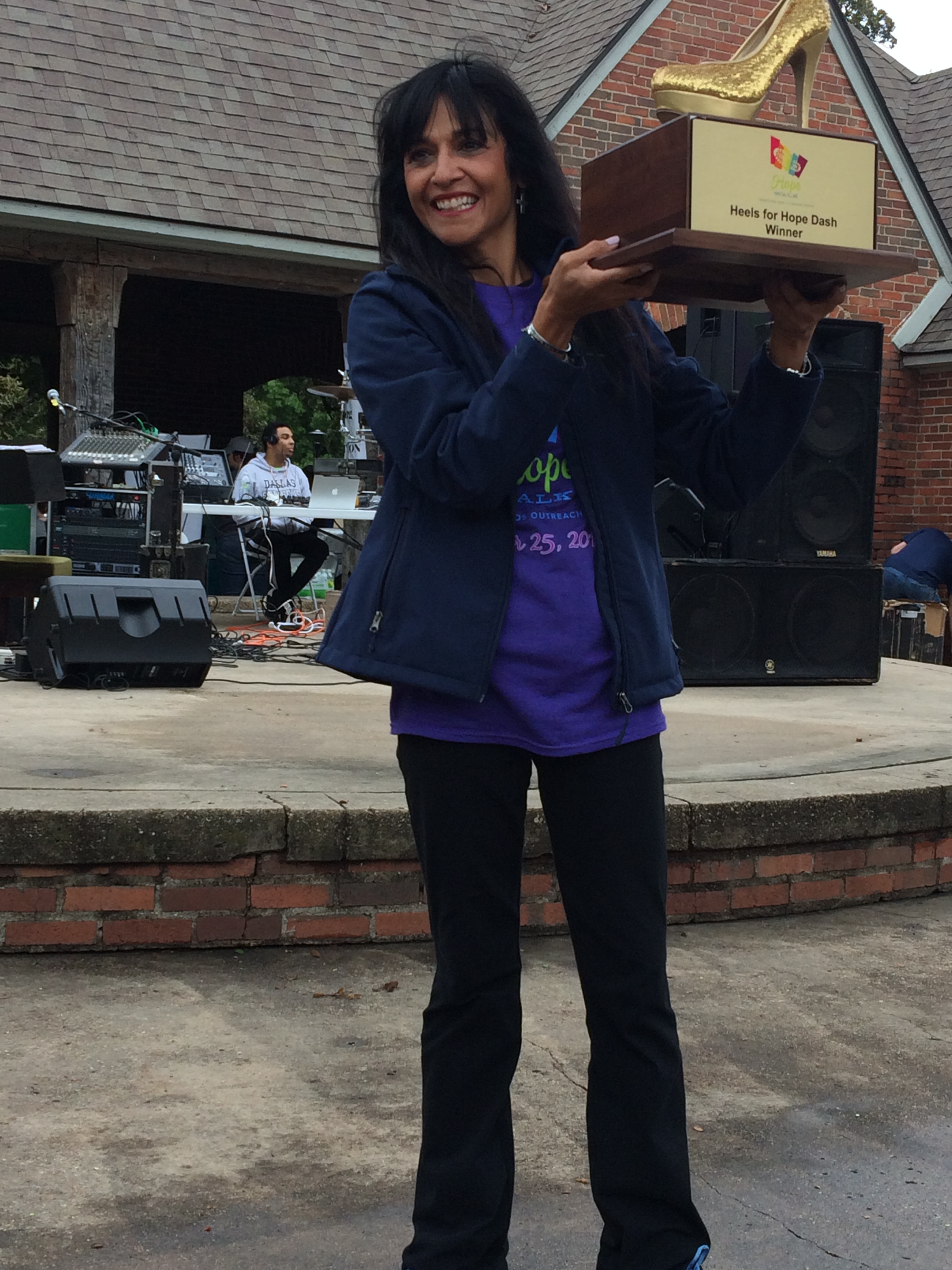 Dr. Di holding the Hope for Heels Trophy