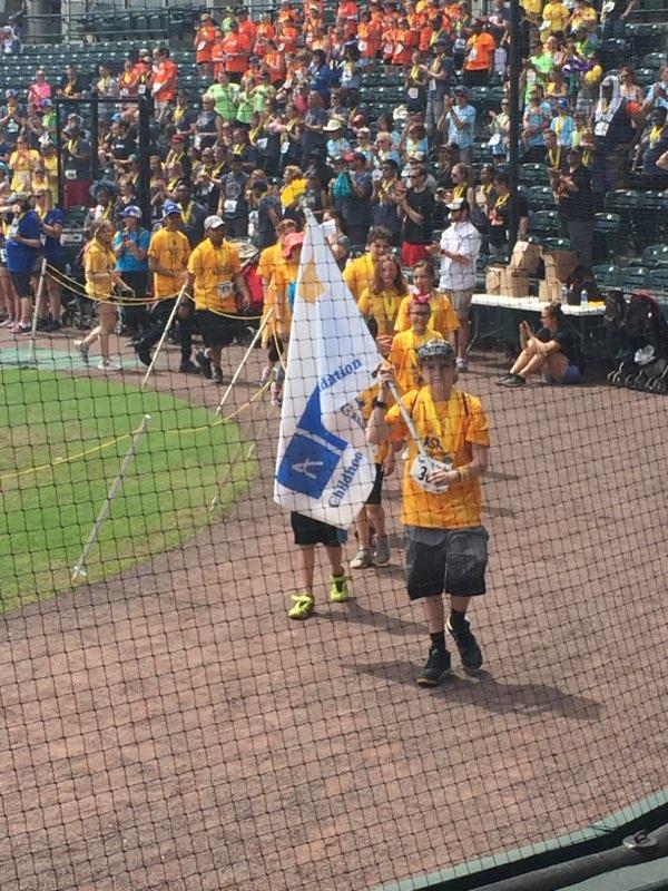 Andrew carrying the flag in the ASK Parade.