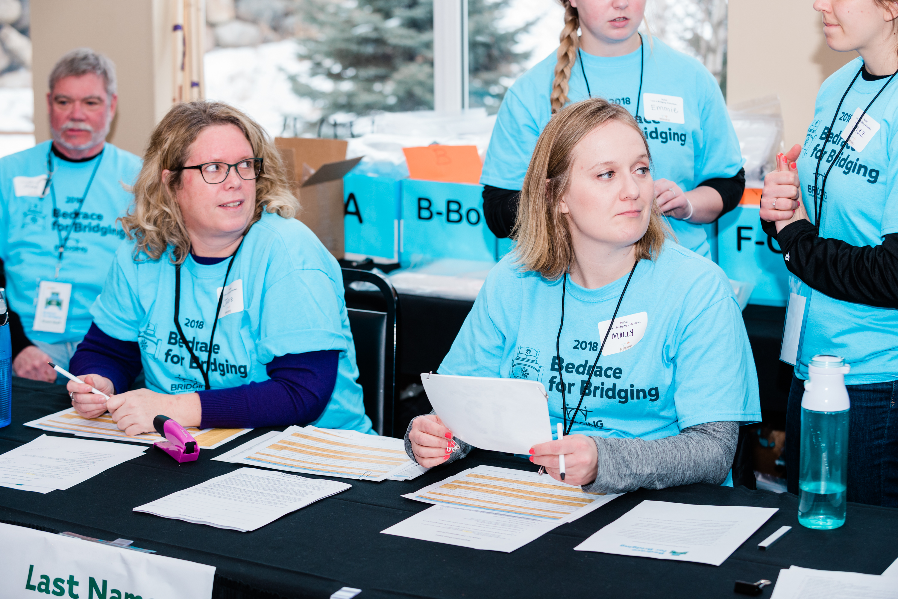 Wonderful Bridging volunteers welcome racers at registration.