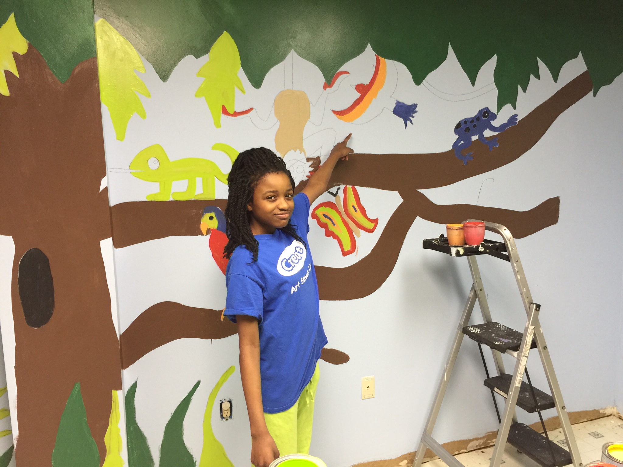 Nydheri helping with a mural