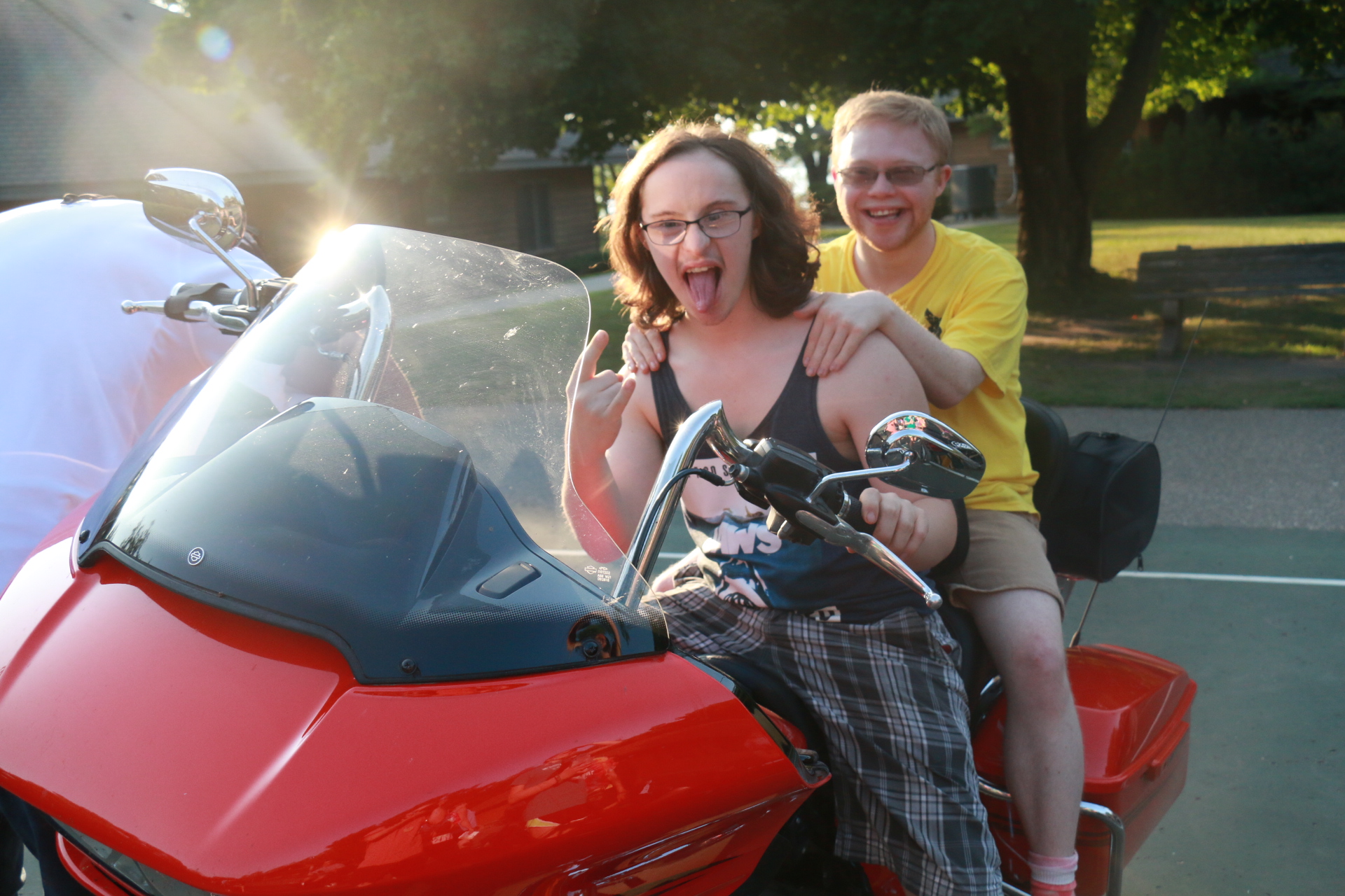 Campers enjoying posing by supporter's motorcycles at camp
