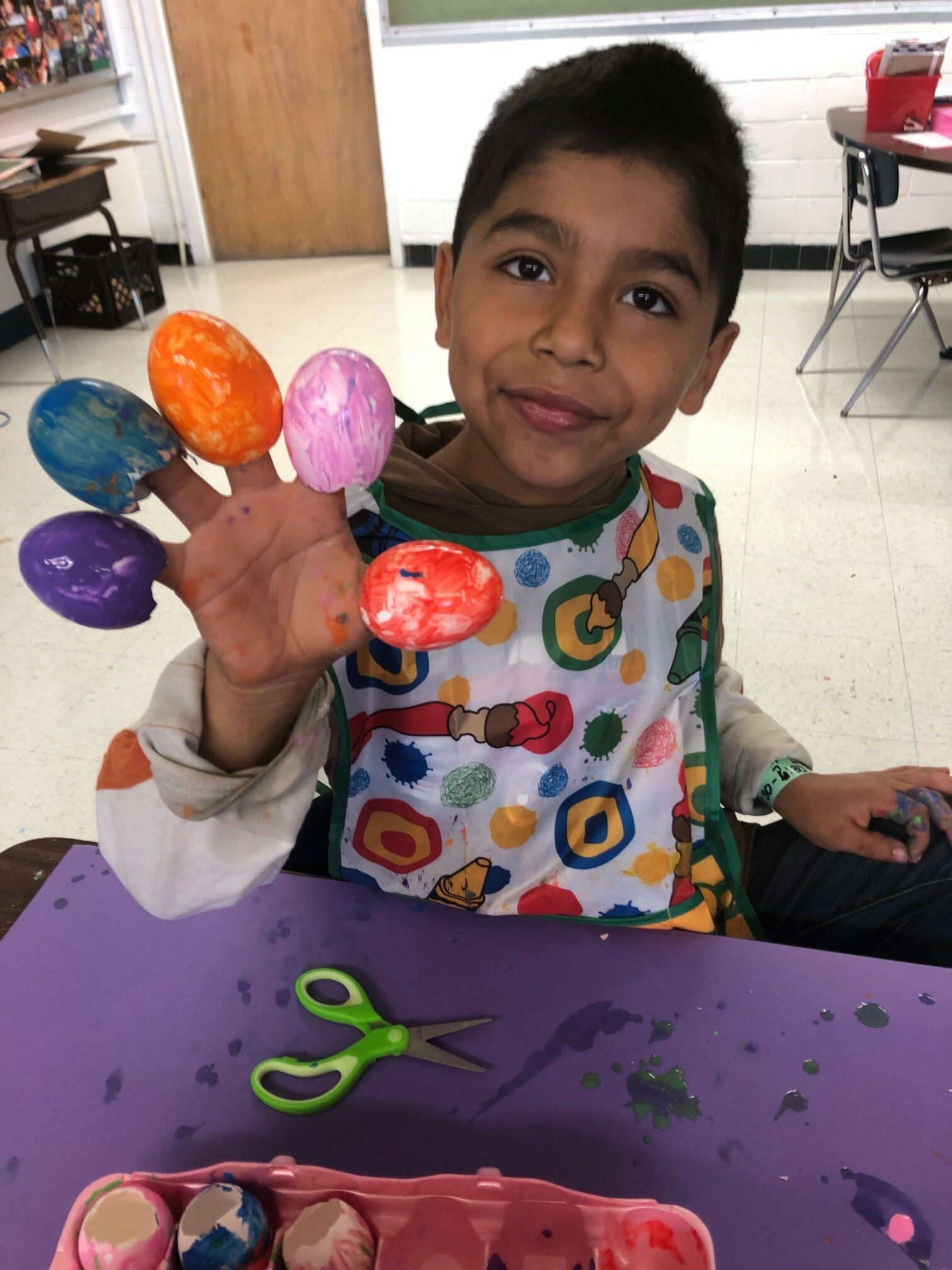CIS student painting eggs for Cascarones art project