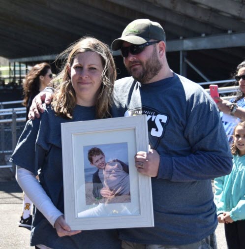 Alex's Army Co-Founders Jenni & Derek Green hold a photo of their son Alex on what would have been his 13th birthday