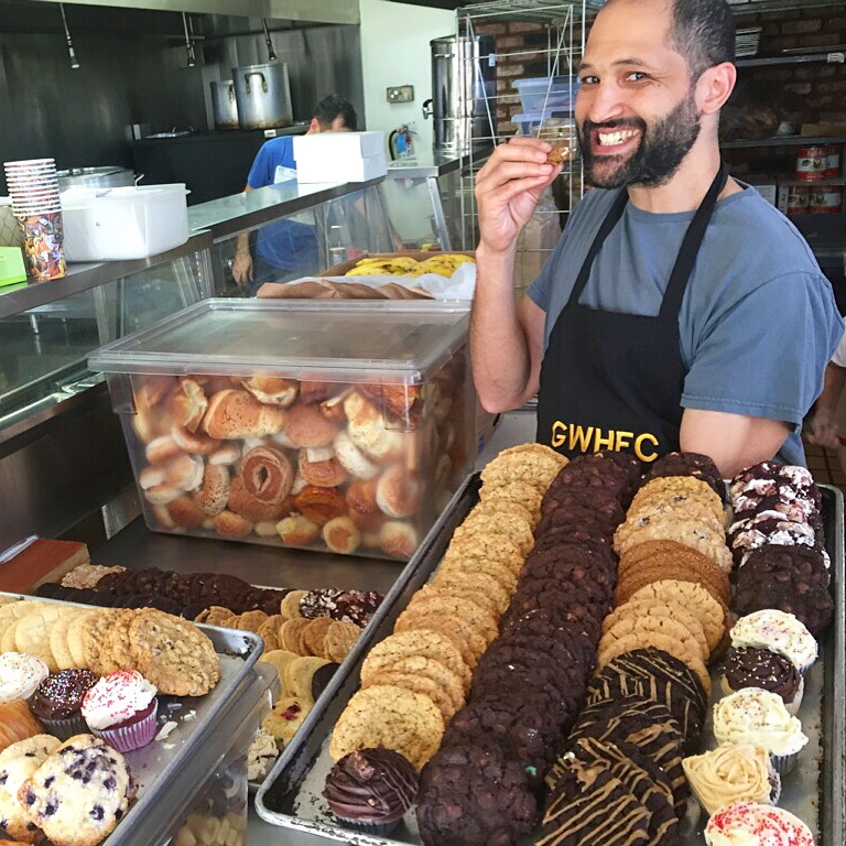 A Volunteer with some of the GWHFC's delicious desserts