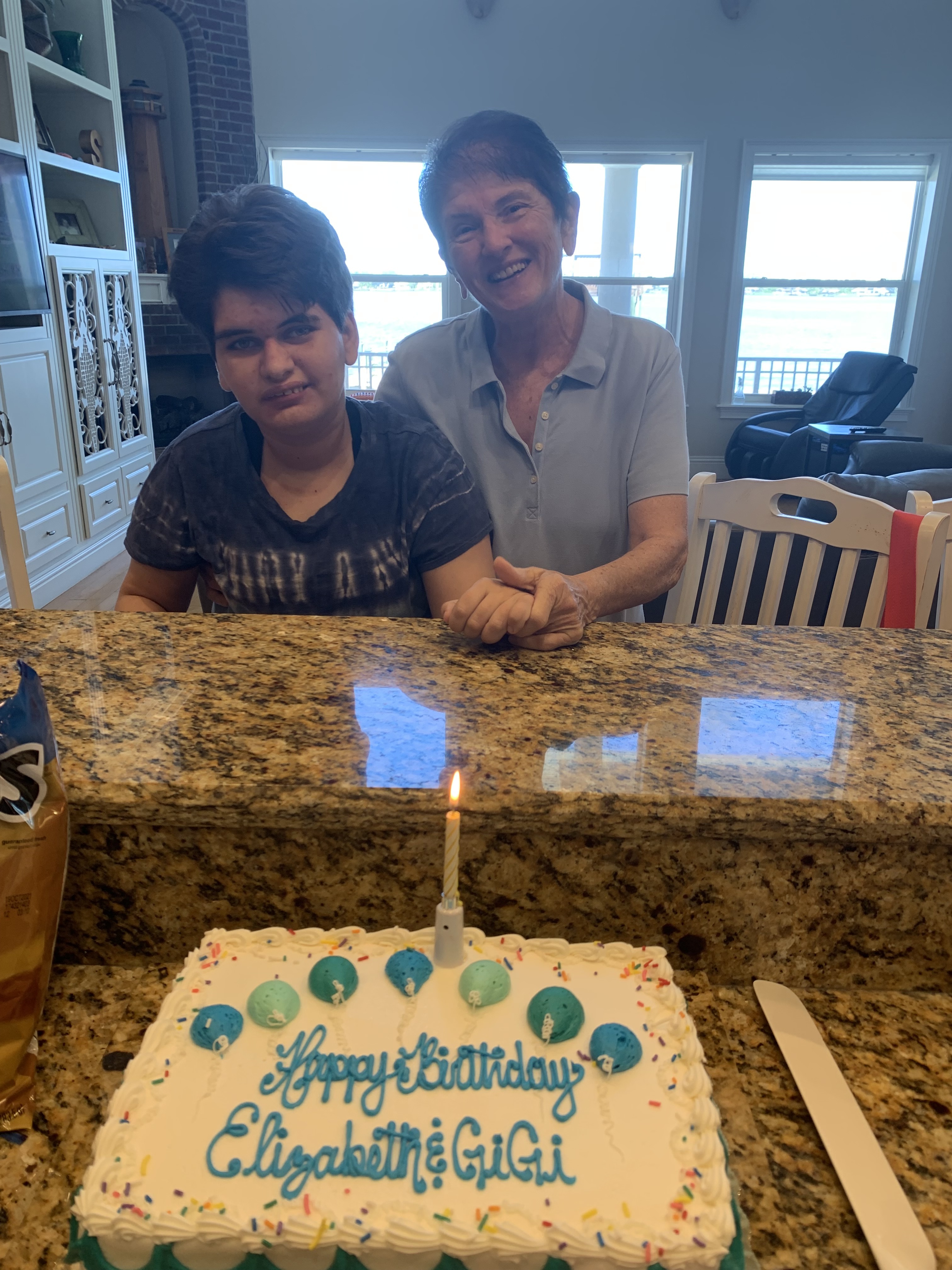 Elizabeth sharing her birthday cake with her Gigi whose birthday is the week before