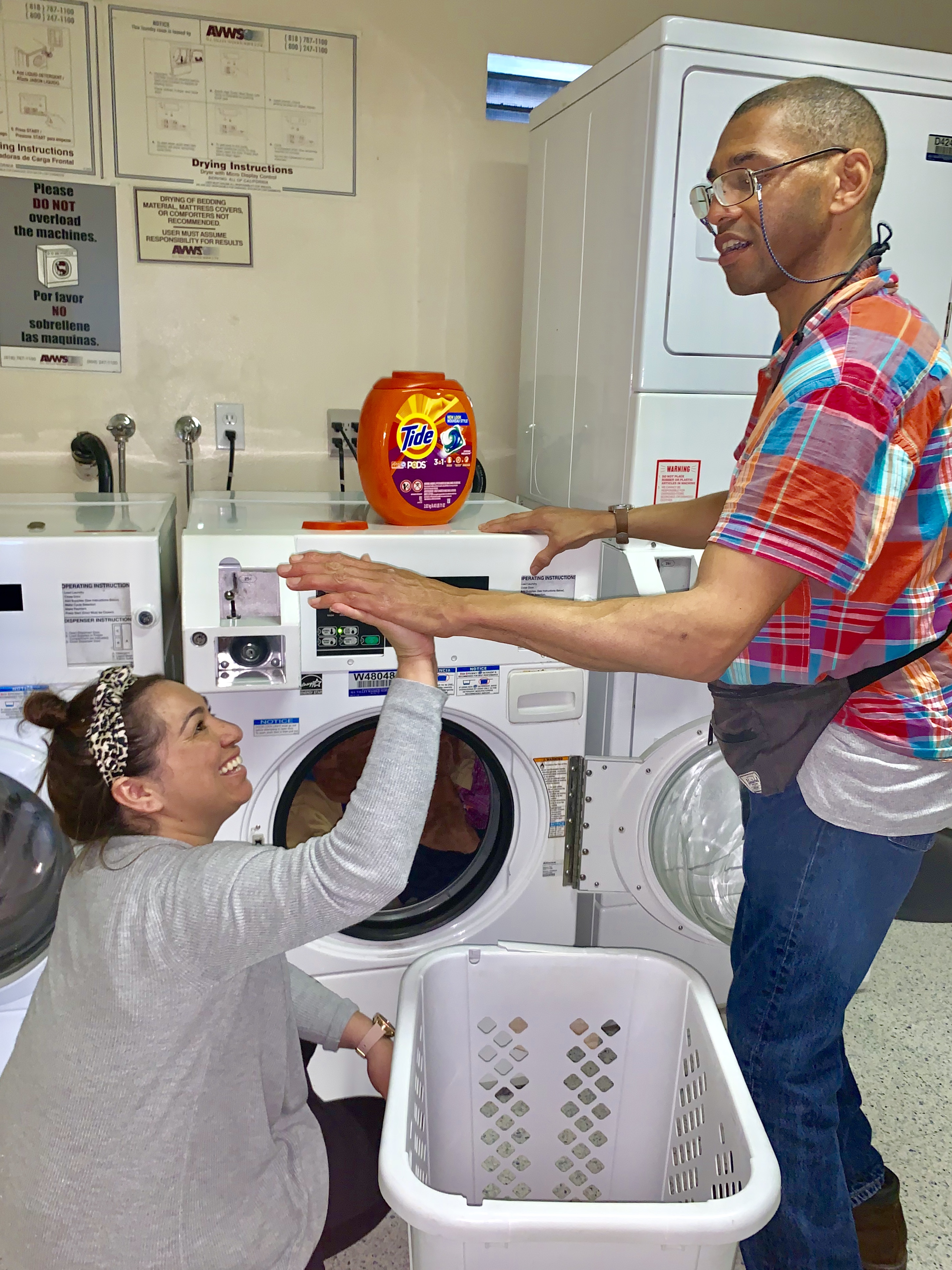 TASC Client, Bruce doing laundry with TASC Coordinator, Diana