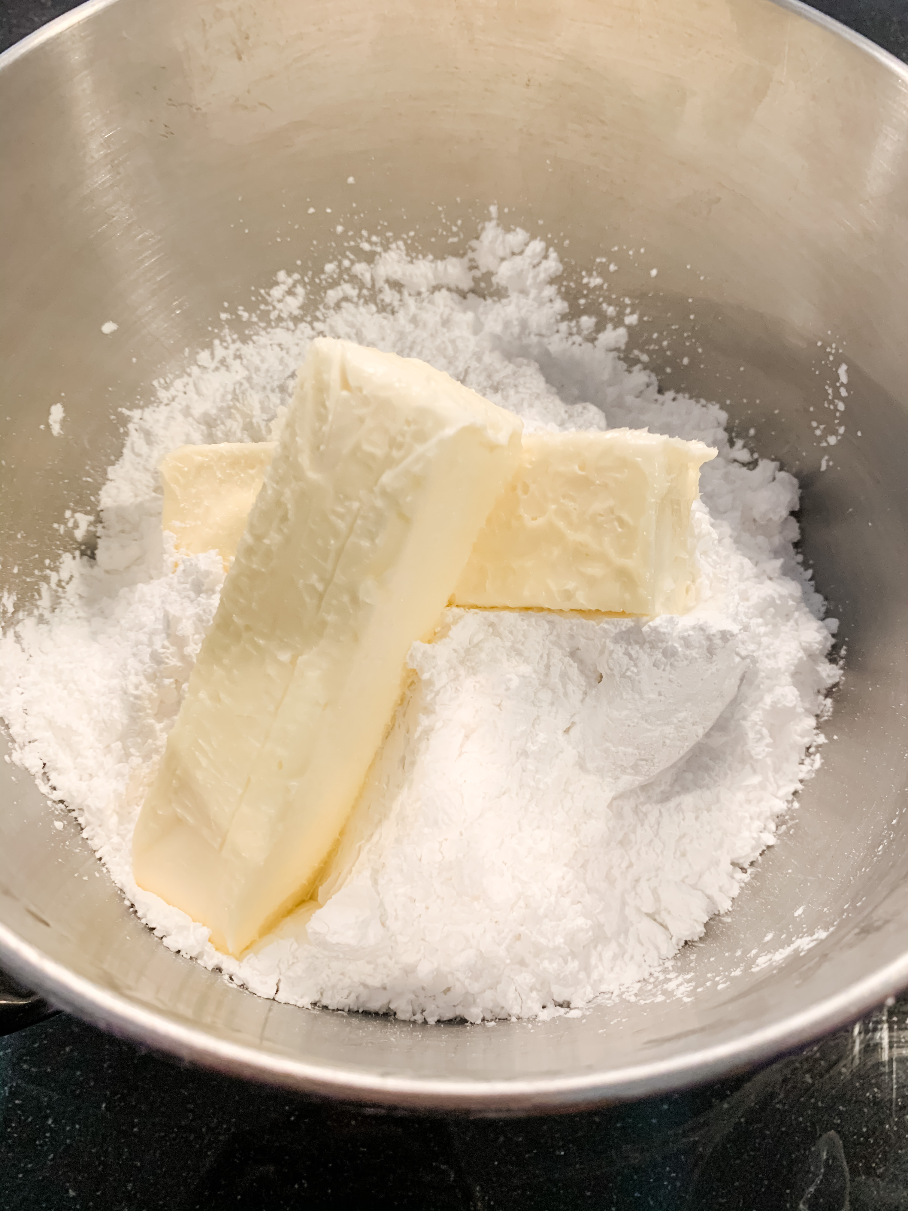 STEP 14 : While the cupcakes are baking, it's icing time! WARNING - it's about to get messy. There's no avoiding it. Just embrace it. Turn the mixer on and just enjoy the powdered sugar storm that will be your kitchen. Add additional powdered sugar as needed and mix thoroughly until your icing is the perfect spreadable consistency.