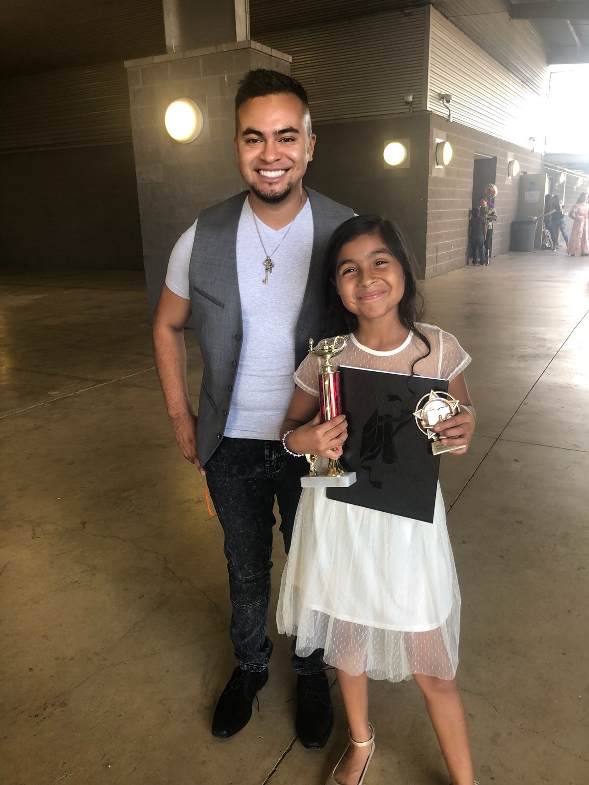 CIS staff attending CIS student's 5th grade graduation ceremony