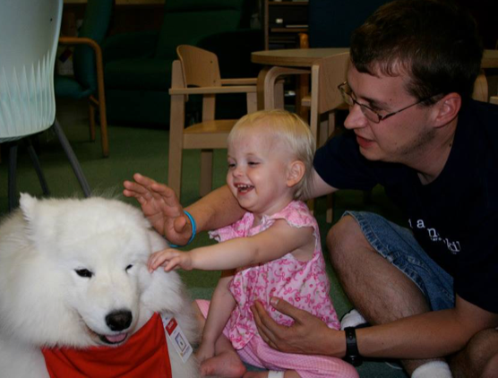 Jess and Daddy with Sasha, the therapy dog at Children's St. Paul