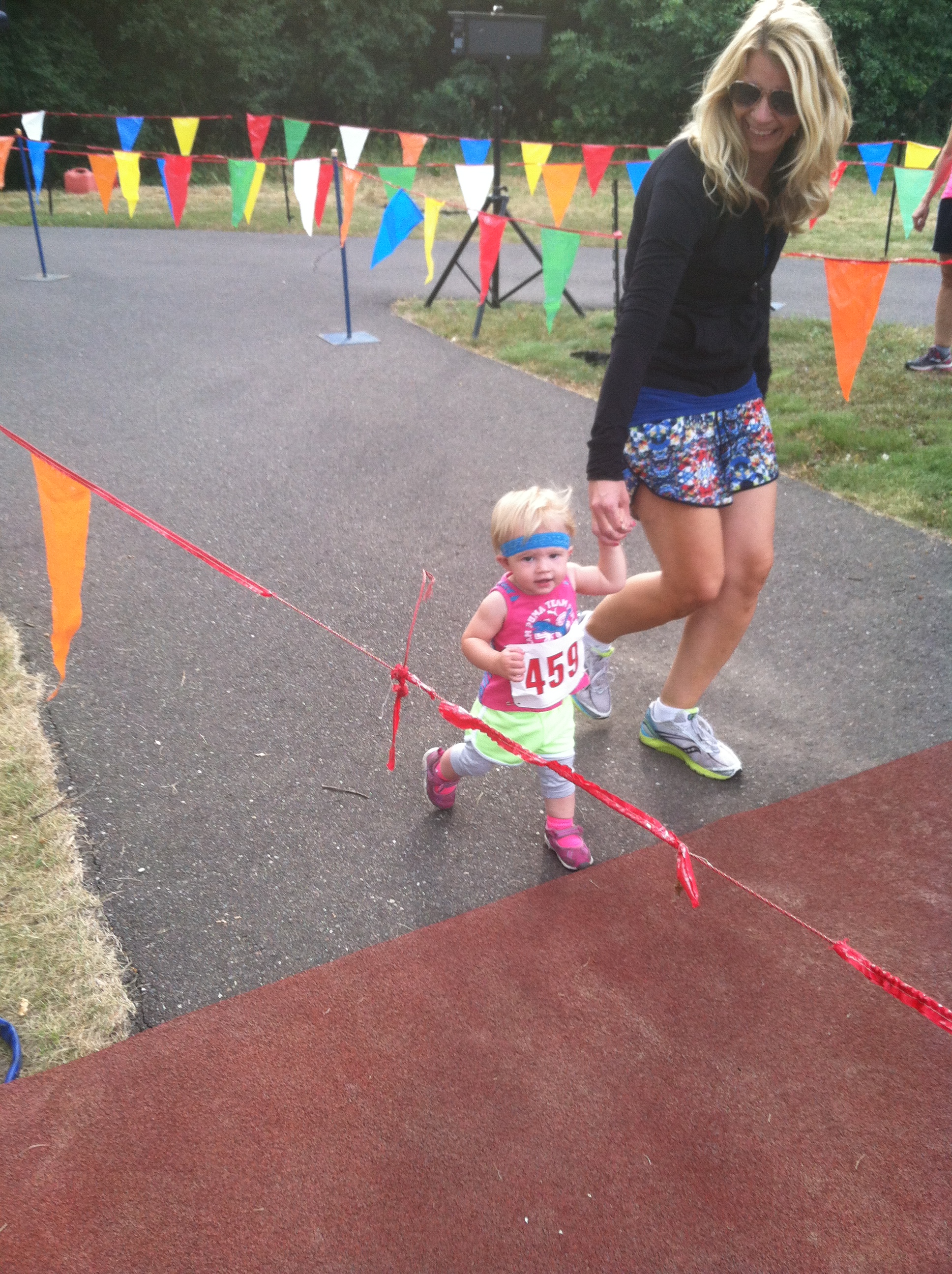 Kenley and I crossing the finish at her first race (age 1)