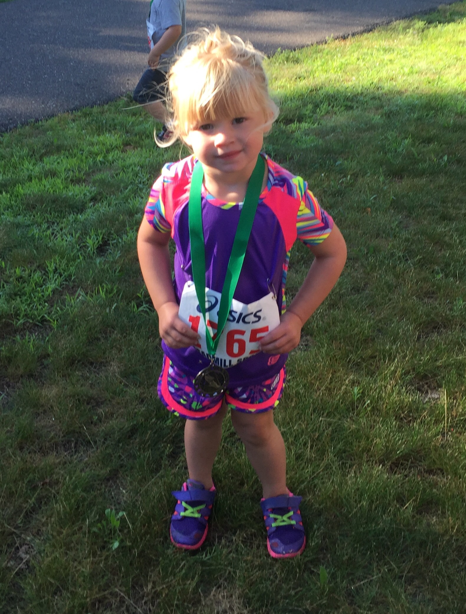 Kenley showing off her medal after her 3rd race (age 3)
