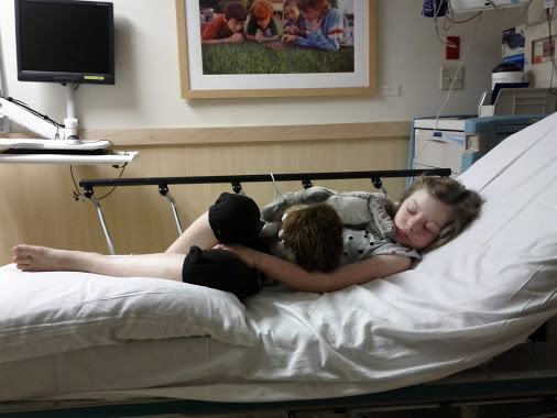 Maggie cuddling with friends at Children's, 2012