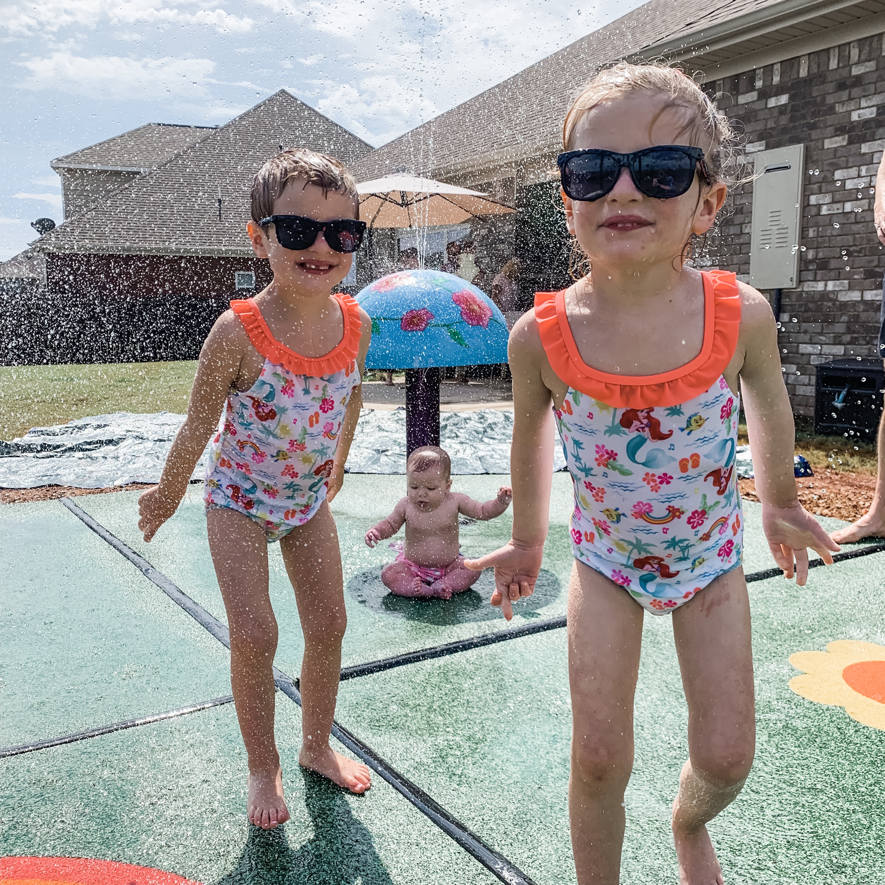 The girls in their backyard splash pad!