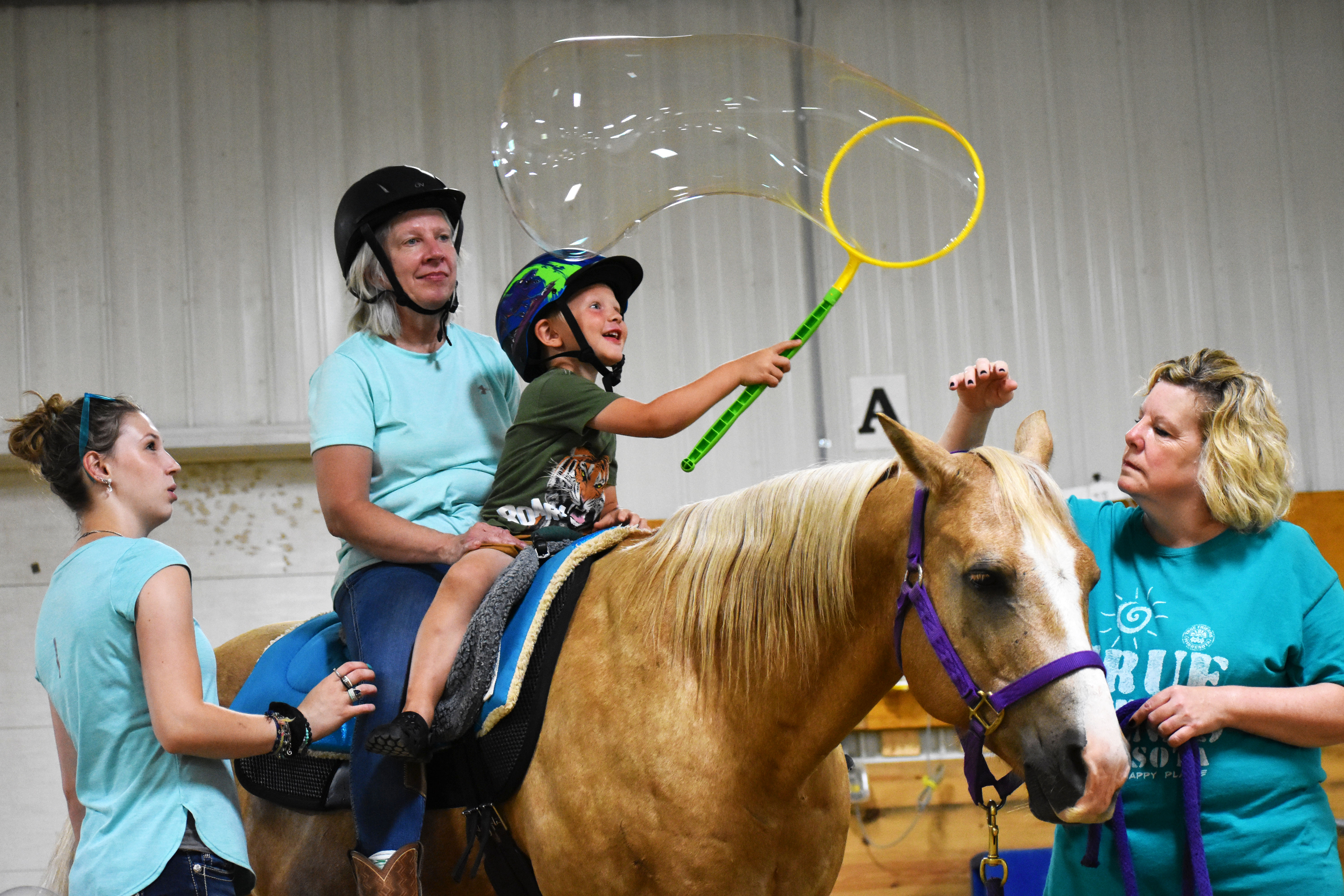 Horse therapy helps builds muscle control and coordination while playing fun games 